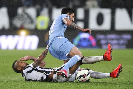 Juventus' Arturo Vidal (bottom) fights for the ball with Lazio's Danilo Cataldi during their Italian Serie A soccer match at Juventus Stadium in Turin April 18, 2015. REUTERS/Giorgio Perottino