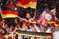 BERLIN, GERMANY - JUNE 13: German soccer fans cheer during the match of their team's second match during the UEFA EURO 2012 group B match between Netherlands and Germany at a public viewing zone called 'fan mile' near the Brandenburg Gate on June 13, 2012 in Berlin, Germany. Germany won 2:1 versus Netherlands. (Photo by Andreas Rentz/Getty Images)