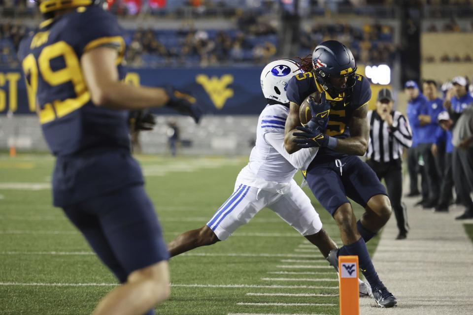 West Virginia’s Devon Carter, right, is forced out of bounds by BYU’s Eddie Heckard during the first half of an NCAA college football game on Saturday, Nov. 4, 2023, in Morgantown, W.Va. West Virginia won 37-7. | Chris Jackson, Associated Press