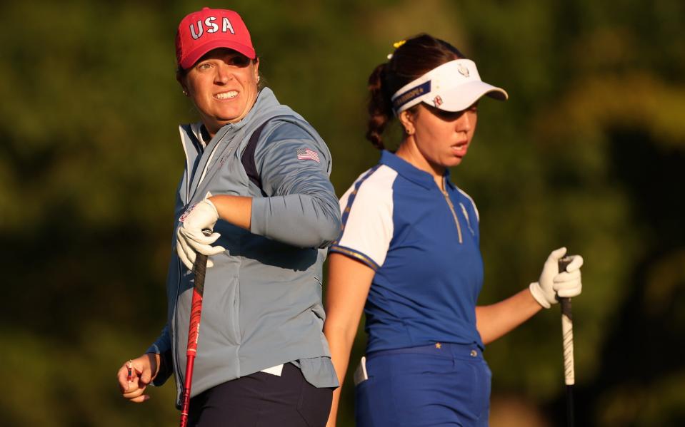 Lauren Coughlin of Team United States and Georgia Hall of Team Europe walk on the third tee