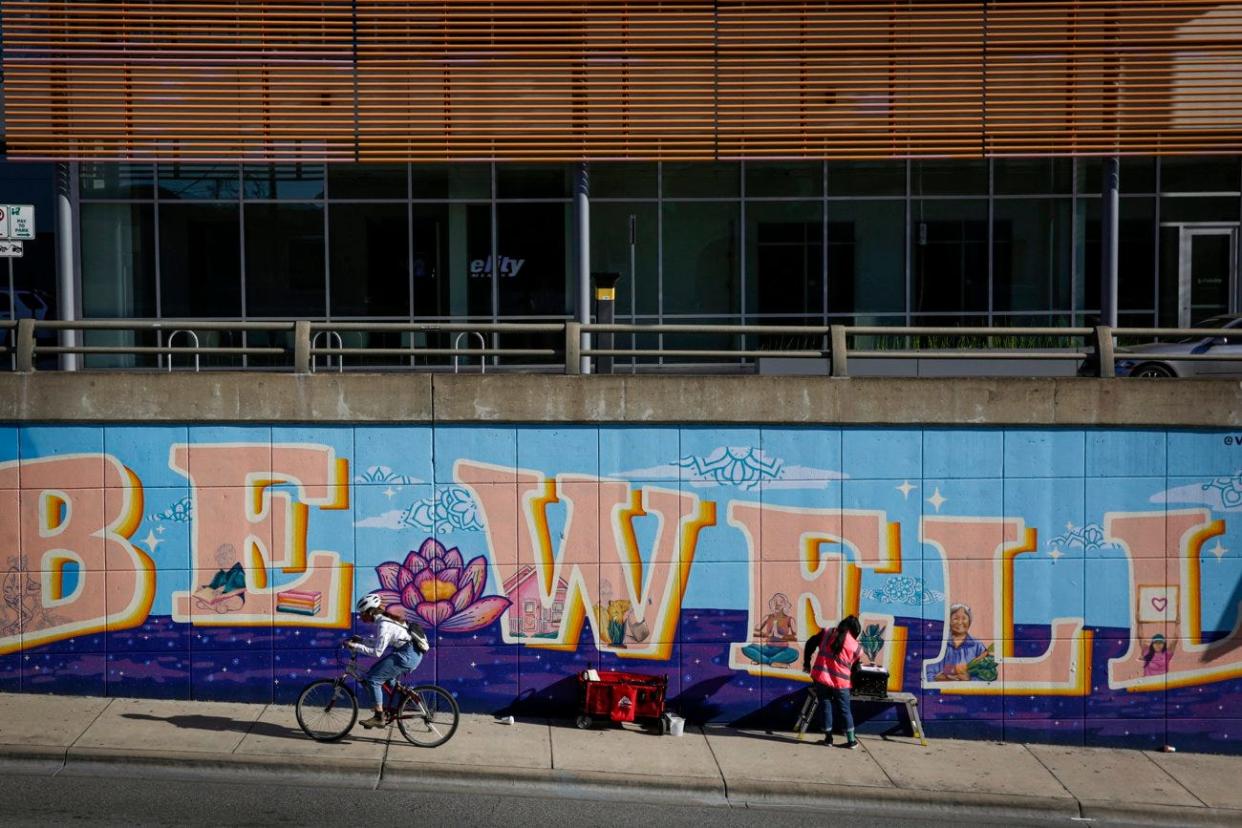 Artist Carmen Rangel works on a mural on North Lamar in Austin on Dec. 17, 2020. The mural's theme centered on mental health and positivity. (Credit: Bronte Wittpenn / American-Statesman / File)