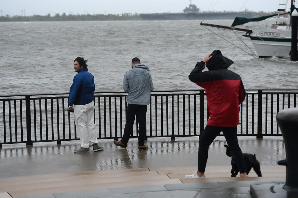 As Hurricane Ian moves near Charleston's coastline area; winds are starting to pick up in the downtown area of the city in the area called 'The Market' near the water front on Sept. 30. The Arthur Ravenel Jr. Bridge near downtown Charleston as Ian moves into the area.  Sam Weinick, 23, left, and Seth Ensley decided to walk out and take a look at the water area in downtown Charleston Friday morning.