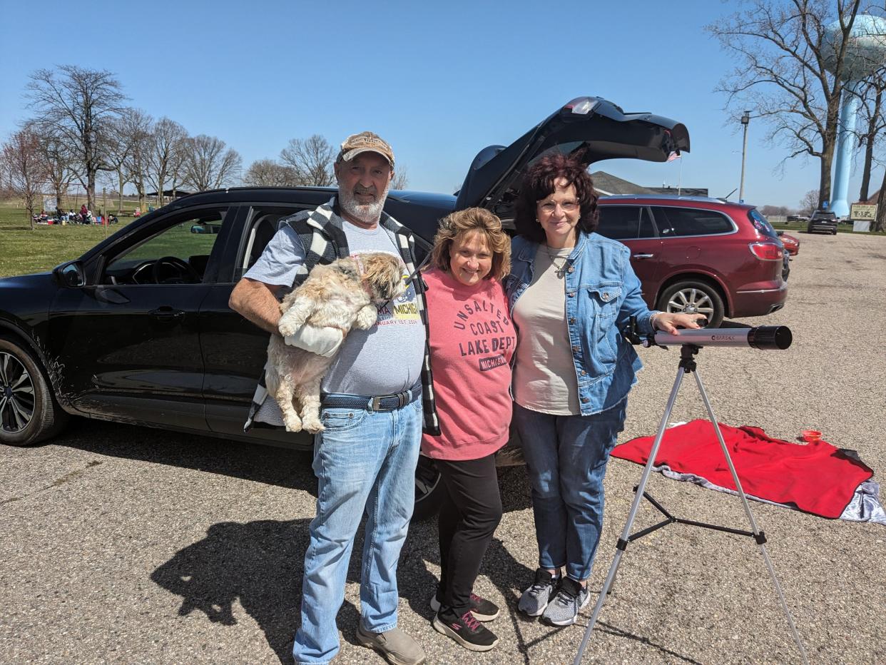 From left: John Gilliam, Rita Gilliam and Lori Filippelli of Canton prepare to watch the solar eclipse in Luna Pier on April 8, 2024.