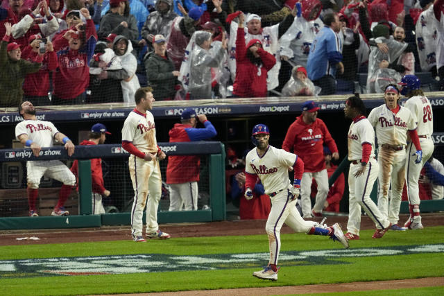 Philadelphia Phillies starting pitcher Ranger Suarez and catcher J.T.  Realmuto celebrate after winning the baseball NL Championship Series  against the San Diego Padres on Sunday, Oct. 23, 2022, in Philadelphia. (AP  Photo/Brynn