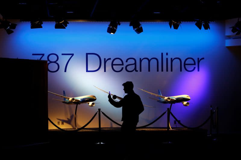 A journalist records a video before a delivery ceremony of the new Boeing 787-10 Dreamliner at Boeing South Carolina in North Charleston
