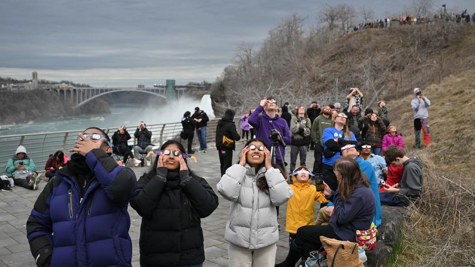 <div>People look up at the sun during a total solar eclipse across North America, at Niagara Falls State Park in Niagara Falls, New York, on April 8, 2024. (Photo by ANGELA WEISS/AFP via Getty Images)</div>