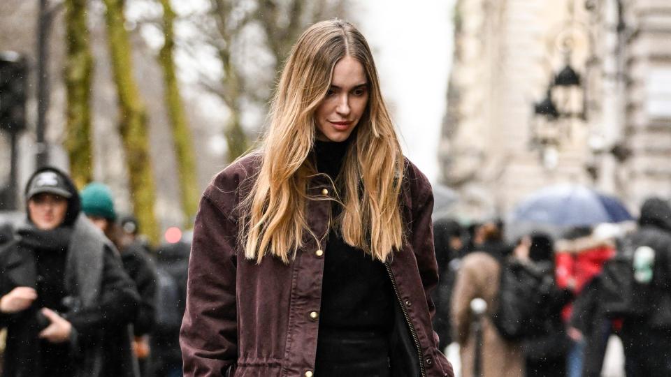 Pernille Teisbaek is seen wearing a maroon jacket, black top, black shorts, black heels and maroon Hermes bag outside the Hermes show during the Womenswear Fall/Winter 2024/2025