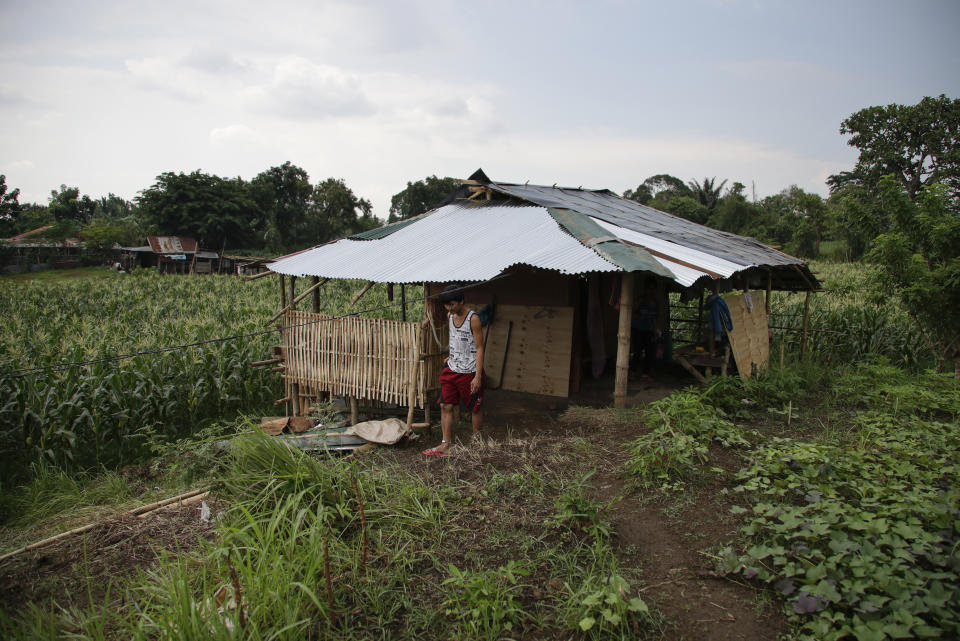 Ronnel Manjares walks outside his house in Tanauan, Batangas province, Philippines, Wednesday, July 15, 2020. His 16-day-old son Kobe Manjares was heralded as the country's youngest COVID-19 survivor. But the relief and joy proved didn't last. Three days later, Kobe died on June 4 from complications of Hirschsprung disease, a rare birth defect. (AP Photo/Aaron Favila)