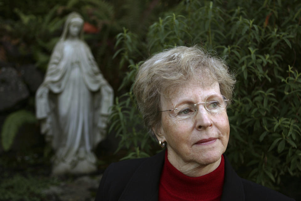 FILE - Church abuse victim Mary Dispenza looks on at her Bellevue, Wash., home, Saturday, Dec. 2, 2006. Dispenza, who endured abuse from both a childhood priest and a nun in her former order, started an online support group with the Survivors Network of those Abused by Priests, or SNAP. (AP Photo/Kevin P. Casey, File)