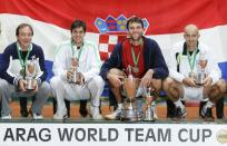 FILE PHOTO: Croatia's team chief Riccardo Piatti, Mario Ancic, Ivo Karlovic and Ivan Ljubicic pose with their trophies after their 2-1 victory over Germany in the World Team Cup final in Duesseldorf, Germany
