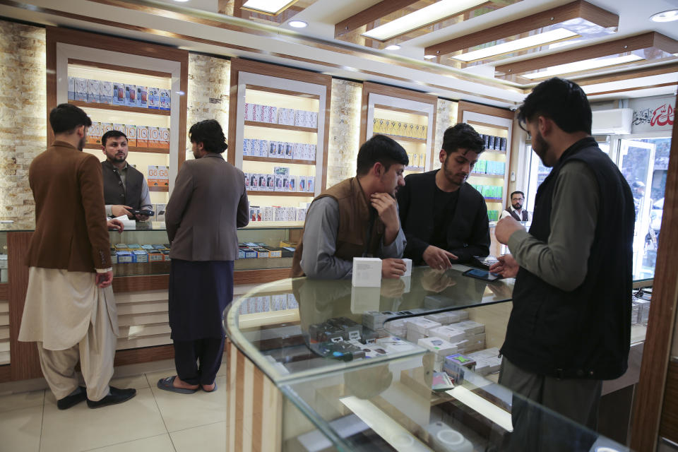 Afghans buy mobile phones in Kabul, Afghanistan, on Tuesday, April 23, 2024. (AP Photo/Siddiqullah Alizai)