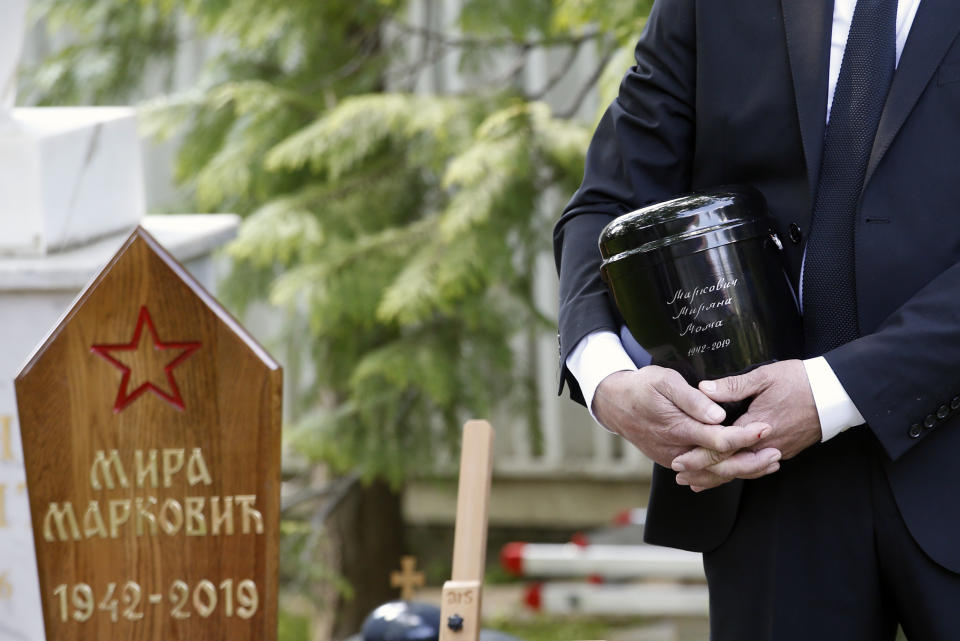 A family friend Slobodan Bulatovic holds urn with ashes of Mirjana Markovic, the widow of former strongman Slobodan Milosevic during her funeral at the yard of his estate in his home town of Pozarevac, Serbia, Saturday, April 20, 2019. Markovic died last week in Russia where she had been granted asylum. The ex-Serbian first lady had fled there in 2003 after Milosevic was ousted from power in a popular revolt and handed over to the tribunal in The Hague, Netherlands. (AP Photo/Darko Vojinovic)