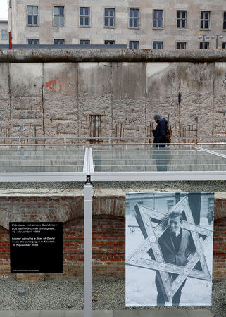 Visitors walk beside remains of the Berlin Wall at the Topography of Terror museum located at the site of the former Nazi Gestapo and SS headquarters, as Germany marks the 80th anniversary of Kristallnacht, also known as Night of Broken Glass in Berlin, Germany, November 9, 2018. REUTERS/Fabrizio Bensch