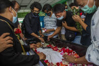 FILE - In this March 16, 2021, file photo, a man weeps at the funeral of Khant Ngar Hein in Yangon, Myanmar, who was shot in the chest during a protest. One hundred days since their takeover, Myanmar’s ruling generals maintain just the pretense of control over the country. There are fears the military takeover is turning Myanmar into a failed state. (AP Photo, File)