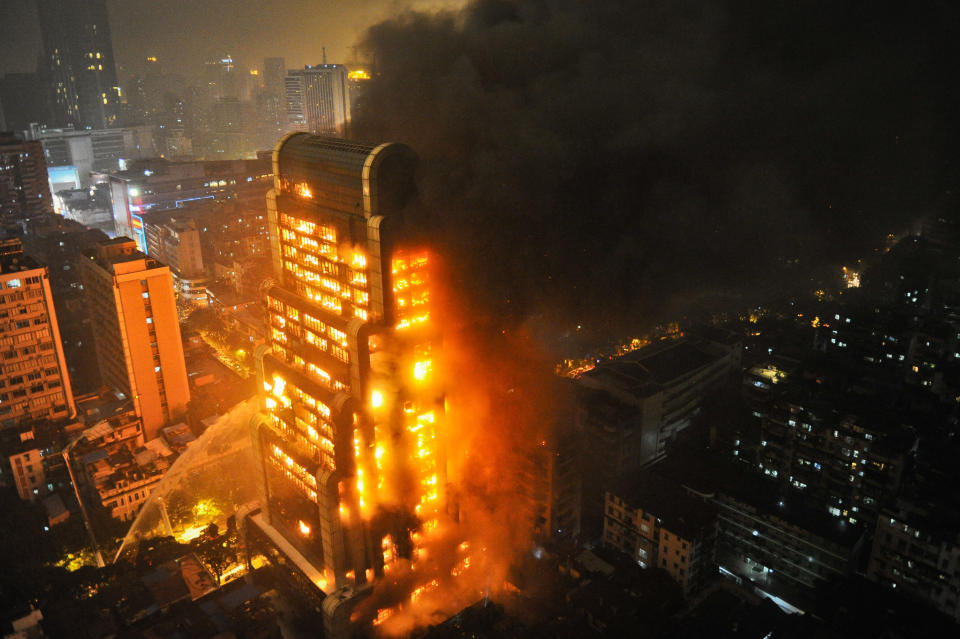 Smoke rises from the burning Jianye building on December 15, 2013 in Guangzhou, China. A fire broke out in the unfinished Jianye Building at about 7 p.m. on Sunday with around 380 firemen attending the blaze, authorities have yet to say whether there are any casualties. (ChinaFotoPress/Getty Images)