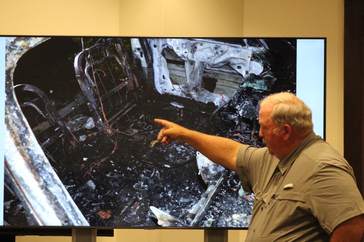 Retired state arson investigator Thomas Murray McDonald Jr. points to a picture of the burned front seat of Tracy Adams' car. Murray testified that is where a fire started. Bernard Thomas is accused of setting Adams on fire, killing her.