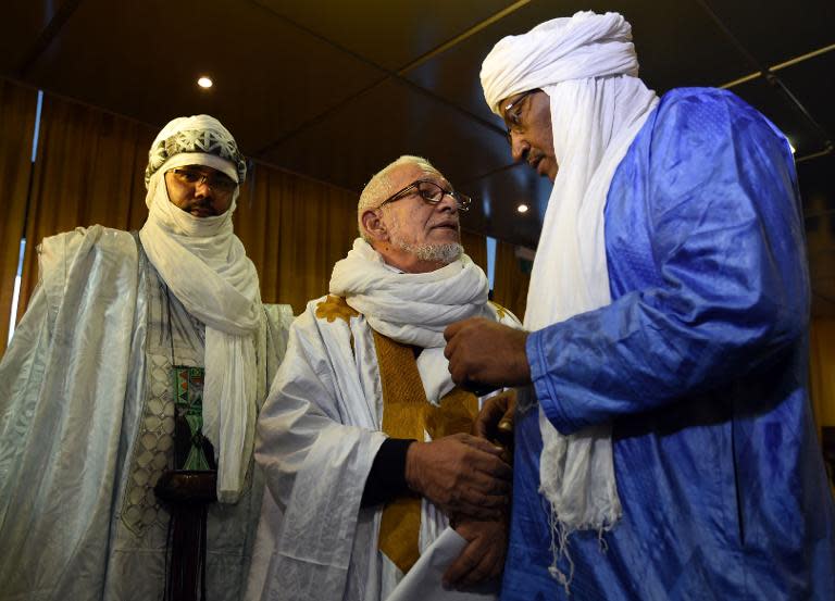 Members of the Tuareg community attend the signing of a peace agreement overseen by Algeria on February 19, 2015