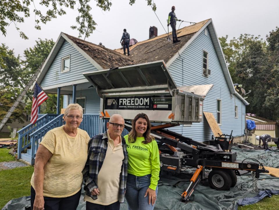 Freedom Roofing Owner Gina Donnell, right, with Army veteran Steven Ickes and his wife Lori. Freedom is working with the Owens Corning Roof Deployment Project to give the Ickes' family a new roof.