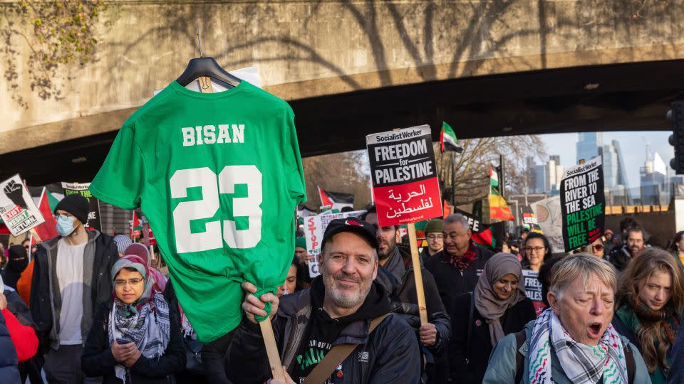 A demonstrator holds a shirt paying tribute to young Palestinian filmmaker Bisan Owda during a pro-Palestinian march in London on December 9, 2023. - Mark Kerrison/In Pictures/Getty Images