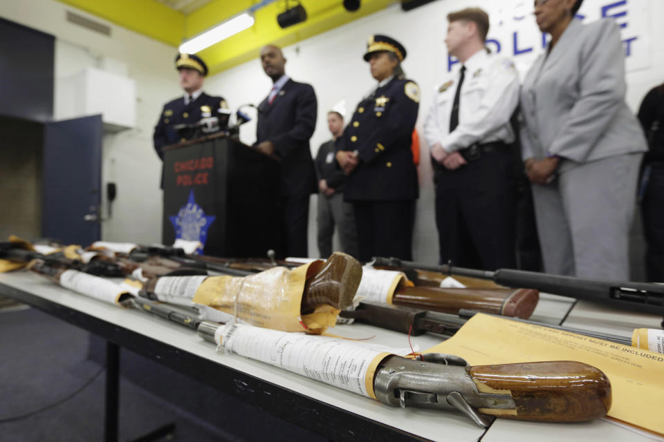 FILE - In this Jan. 28, 2013, file photo, Chicago Police First Deputy Superintendent Alfonsa Wysinger, second from left, speaks at a news conference in Chicago with a display of recently seized guns, part of the 574 that had been seized in the city since Jan. 1. The mounting homicide toll in President Barack Obama’s hometown has giving ammunition to both sides in the nation’s debate about gun rights and safety. On Monday, Jan. 6, 2014, a federal judge in Chicago potentially opened a new market to gun dealers after ruling as unconstitutional Chicago ordinances that aim to reduce gun violence by banning their sale within the city's limits. (AP Photo/M. Spencer Green, File)