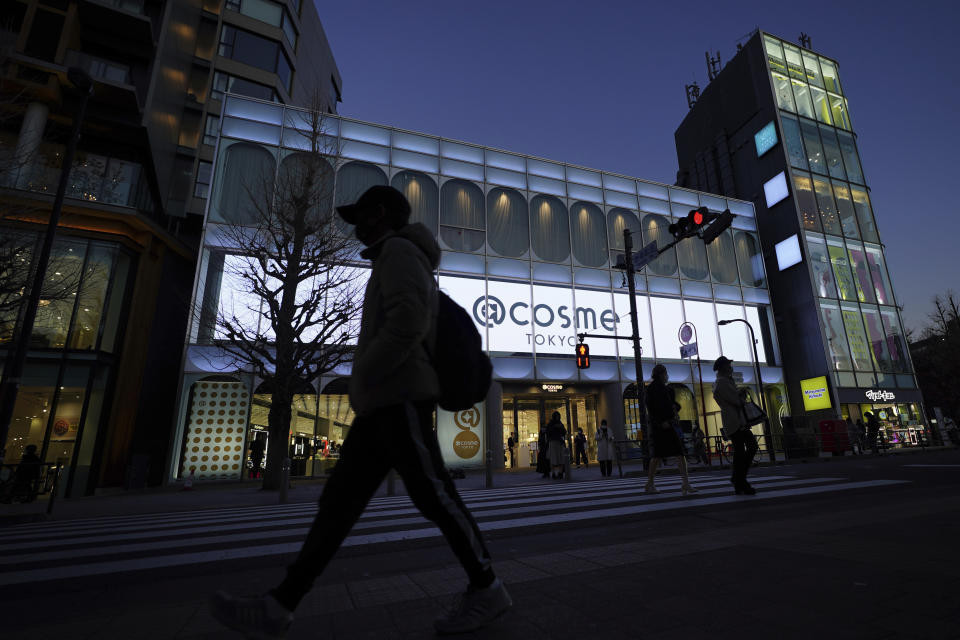 People walk past @cosme TOKYO, a store selling a selection of cosmetics and makeup products including men's cosmetic, in Tokyo's Harajuku district Tuesday, Feb. 9, 2021. The coronavirus pandemic has been pushing businesses to the edge in Japan, but some in the men's beauty industry have seen an unexpected expansion in their customer base. Japanese businessmen in their 40s, 50s and 60s who had little interest in cosmetics before the pandemic are now buying makeup. (AP Photo/Eugene Hoshiko)