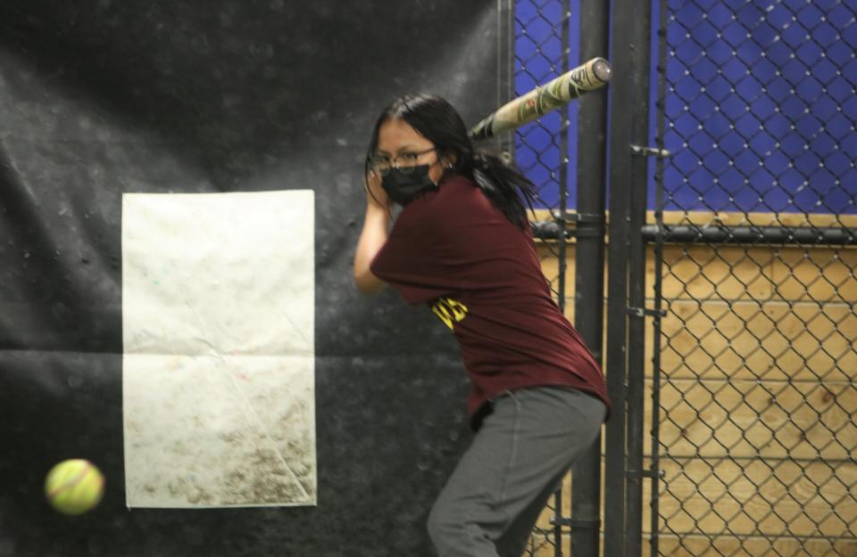 Farmington High School's Stephanie Waybenais prepares to swing at a pitch during softball practice at The Clubhouse, Monday, March 21, 2022