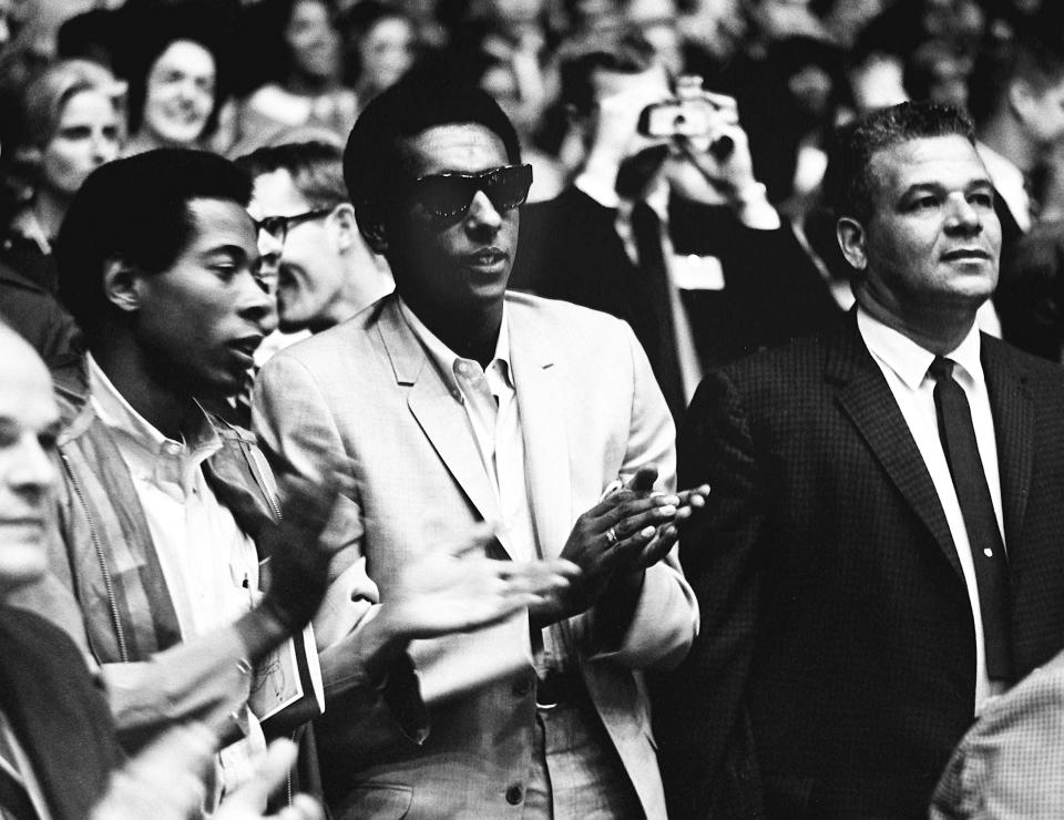 Stokely Carmichael, center, the militant leader of the Student Nonviolent Coordinating Committee, claps for speaker Dr. Martin Luther King Jr. on the first day of the two-day Impact symposium event at Vanderbilt University's Memorial Gym on April 4, 1967. The next day, Carmichael will address the crowd.