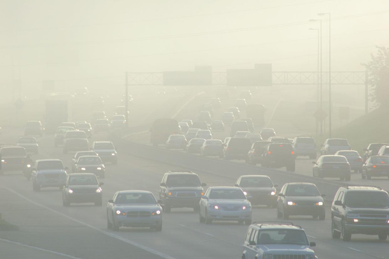 cars at rush hour driving through thick smog