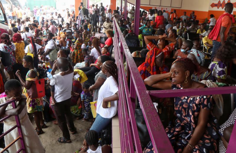 Residents wait at the bus station as they prepare to leave the capital for the remote villages ahead of a contentious election many fear could turn violent, in Abidjan