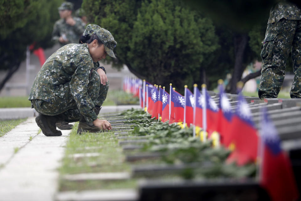 Soldiers salute to the fallen during a ceremony commemorating the 65th anniversary of deadly attack by China on Kinmen island, in Kinmen, Taiwan, Wednesday, Aug. 23, 2023. (AP Photo/Chiang Ying-ying)