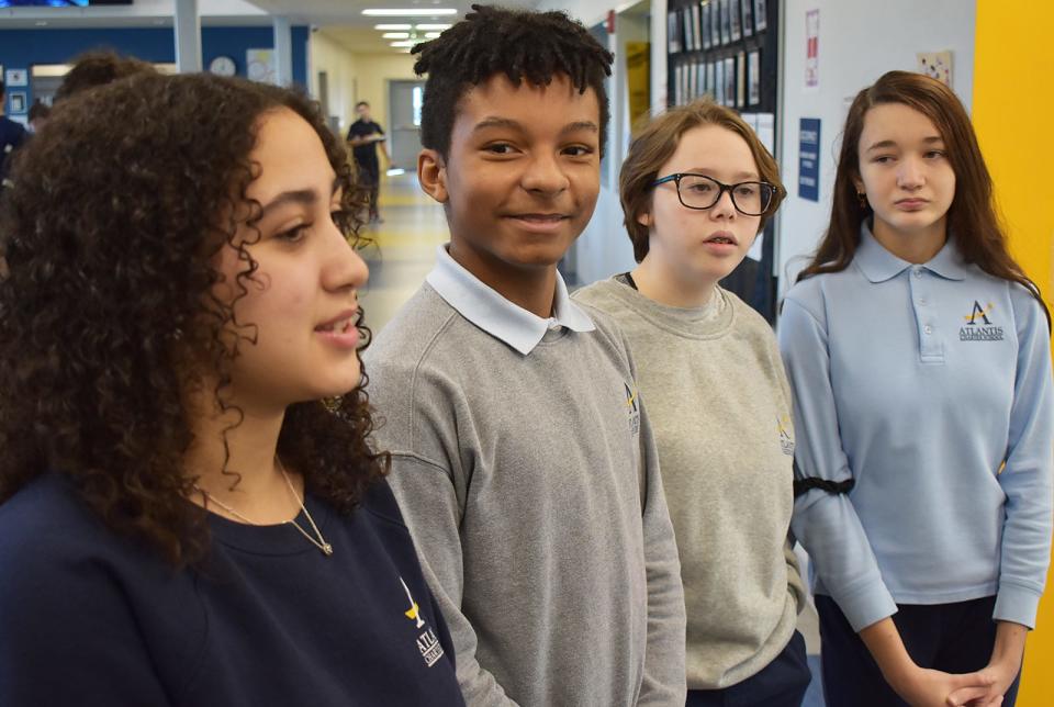 From left, Emma Correia, Jalil Islam, Ella Corriveau and Sophia Esteves, eighth-graders at Atlantis Charter School in Fall River, speak about their civics project writing and illustrating picture books to help teach Haitian migrant children how to speak English.