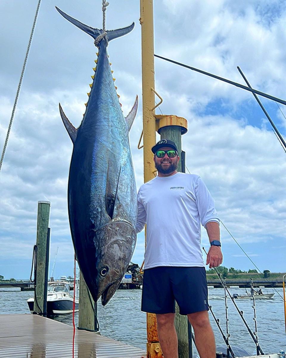 Capt. Kris Black stands next to a giant bluefin tuna landed by him and Ian Bonham, Jeff Paetzold and Bill Young on Black's boat Fish Stix.