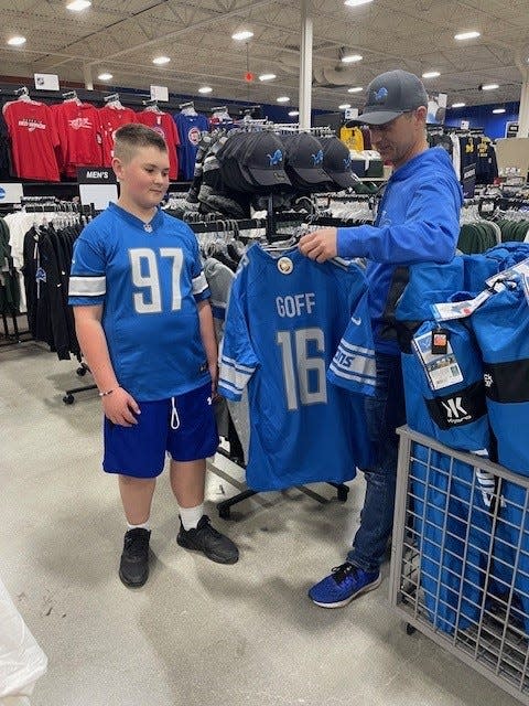 Detroit Lions fan Bryan Ciesielski, 47, of Port Huron made a special exception to take his son Beckett, 11, out of school to drive down to Detroit for the NFL Draft on Friday. They stopped at Dunham's Sports for extra jerseys, and the duo will spend the night downtown.