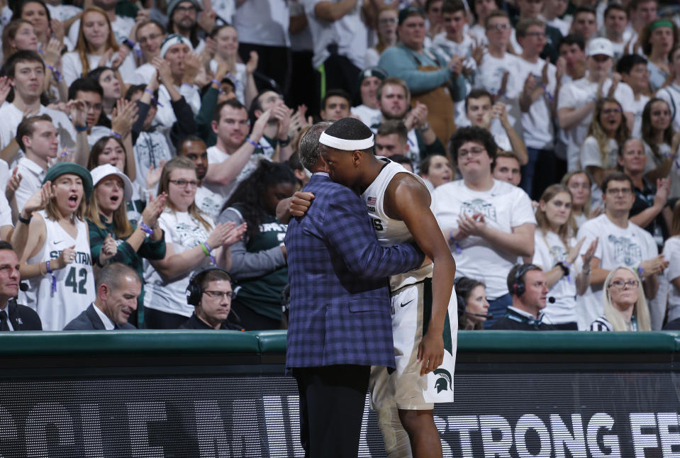 Michigan State's Cassius Winston and coach Tom Izzo embrace as Winston leaves the the team's NCAA college basketball game against Binghamton, Sunday, Nov. 10, 2019, in East Lansing, Mich. Michigan State won 100-47. (AP Photo/Al Goldis)