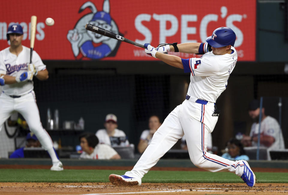 Texas Rangers' Corey Seager hits a single against the Los Angeles Angels in the third inning of a baseball game Saturday, May 18, 2024, in Arlington, Texas. (AP Photo/Richard W. Rodriguez)
