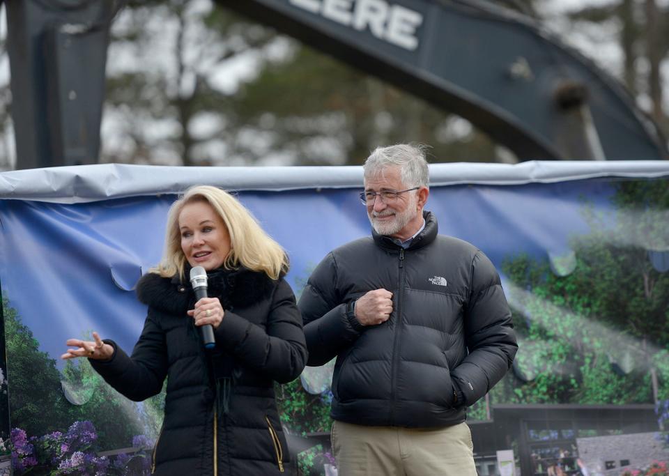 Peter Barbey, right, listens to his wife Pamela Barbey speak about Heritage Museums & Gardens during a groundbreaking ceremony Wednesday. To see more photos, go to www.capecodtimes.com.