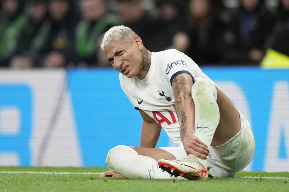Tottenham's Richarlison sits on the pitch in pain during the English Premier League soccer match between Tottenham Hotspur and Fulham at the Tottenham Hotspur Stadium in London, Monday, Oct. 23, 2023. (AP Photo/Kin Cheung)