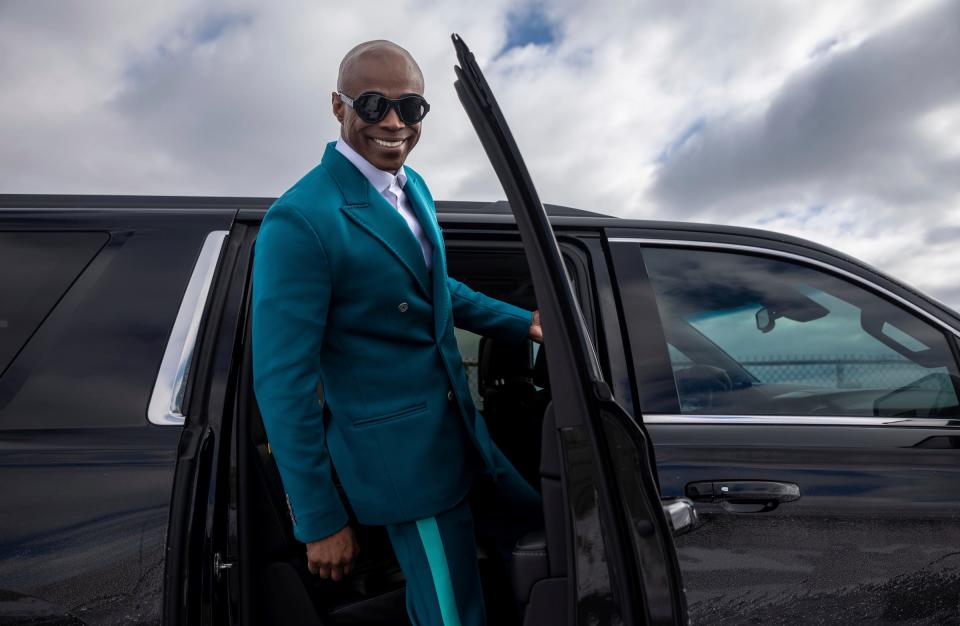 Kem with his vehicle on the Detroit riverfront near the Ambassador Bridge.