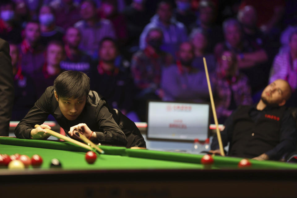 China's Zhao Xintong at the table during day thirteen of the Cazoo UK Championship at the York Barbican, england, Sunday, Dec. 5, 2021. (Richard Sellers/PA via AP)