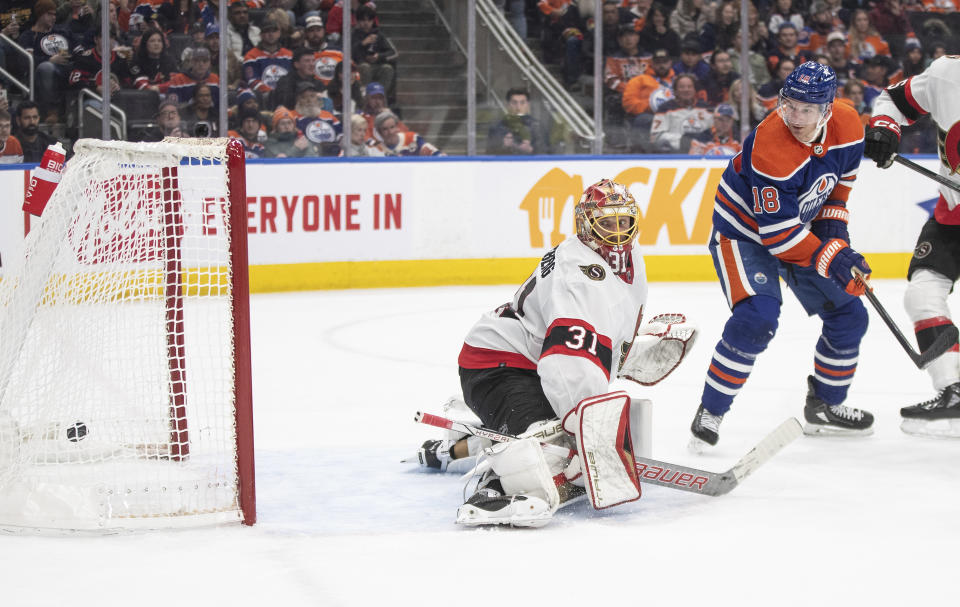 Ottawa Senators' goalie Anton Forsberg (31) gives up a goal as Edmonton Oilers' Zach Hyman (18) watches the shot during the second period of an NHL hockey game Saturday, Jan. 6, 2024, in Edmonton, Alberta. (Jason Franson/The Canadian Press via AP)