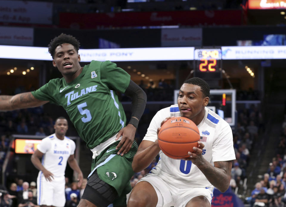 Memphis' forward D.J. Jeffries pushes past Tulane guard Teshaun Hightower (5) in the second half of an NCAA college basketball game Monday, Dec. 30, 2019, in Memphis, Tenn. (AP Photo/Karen Pulfer Focht)