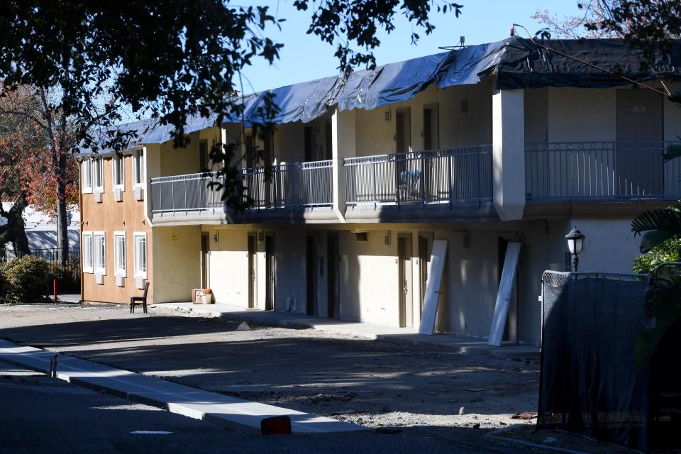 Doors lean against a wall next to an unfinished driveway on Wednesday at the former Quality Inn & Suites in Thousand Oaks. The property was slated to become permanent housing for those previously homeless. Shangri-La Industries, which owns the property, is in financial trouble and has defaulted on loans for this and other properties.