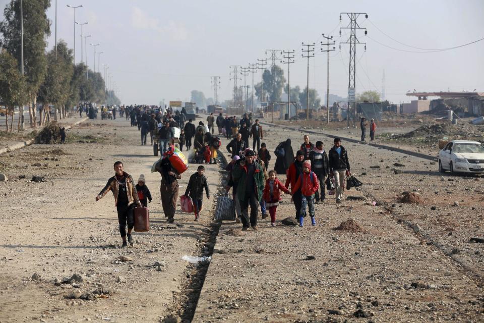 Displaced Iraqis, who fled fighting between Iraqi security forces and Islamic State militants, return to their homes in neighborhoods retaken by Iraqi government forces in the eastern side of Mosul, Iraq, Wednesday, Jan. 4, 2017. (AP Photo/ Khalid Mohammed)