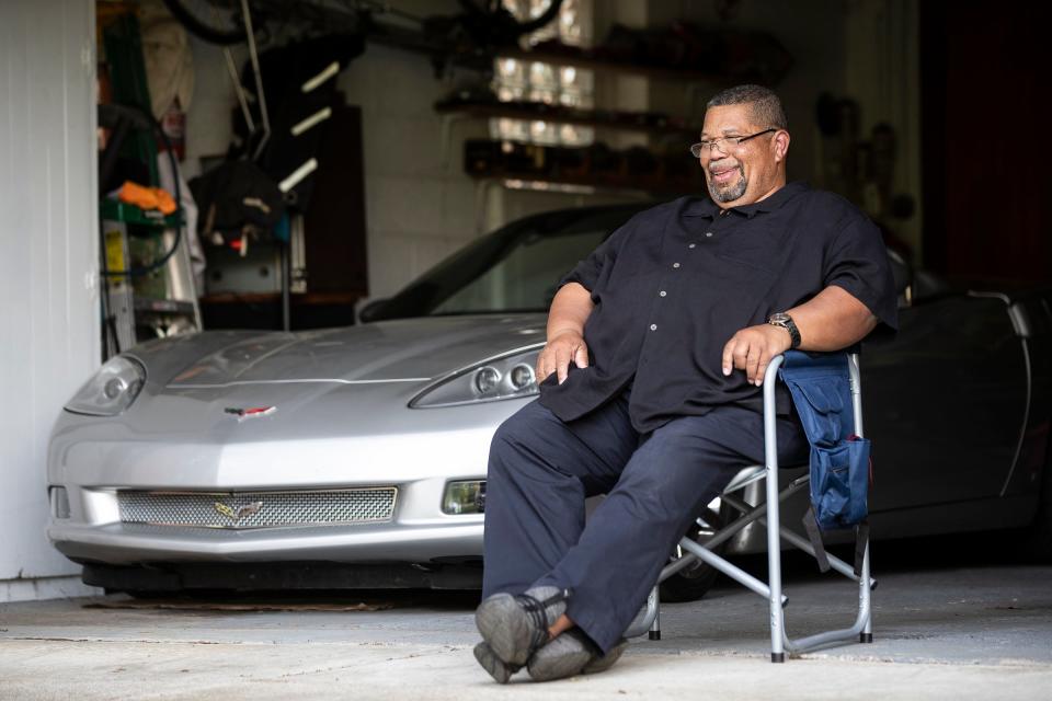 Martin Rucker looks out at the park across from his home in Redford Township, Mich., after coming back from work at a car dealership on May 18. Rucker bought the Corvette as a retirement gift to himself in 2022.