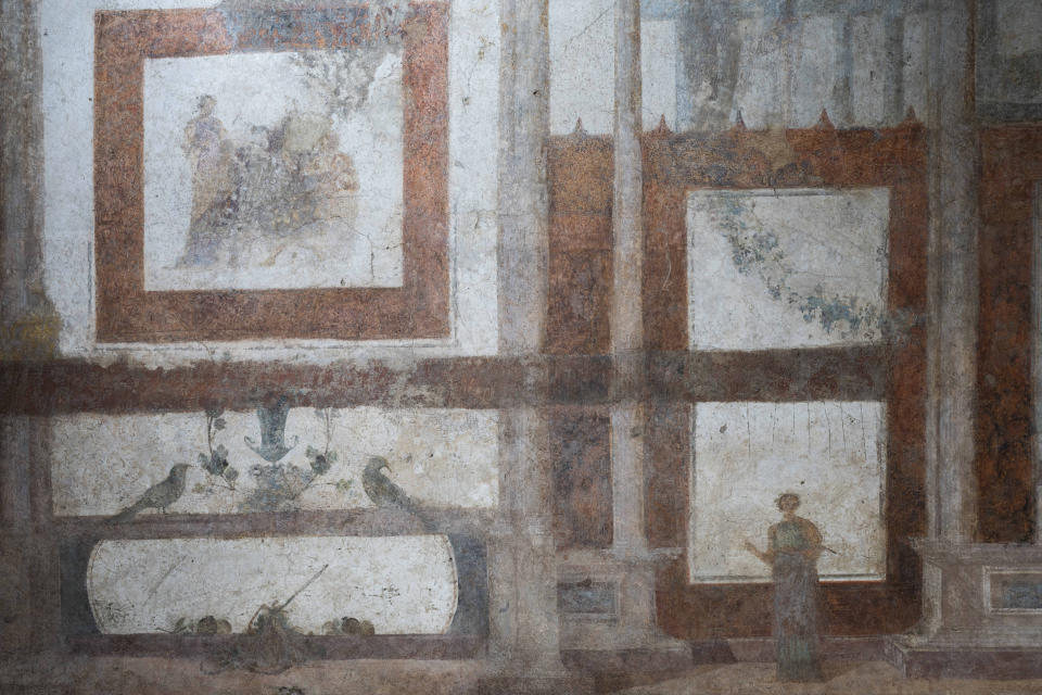 A detail of the frescoes coming from the sacellum, a small votive chapel, of a two-story home, or "Domus," dating from around 134-138 AD that was partially destroyed to make way for the construction of the Caracalla public baths, which opened in 216 AD, are on display at the Caracalla archaeological park in Rome, Thursday, June 23, 2022. The frescoed ceiling and walls of a domestic temple honoring Greco-Roman and Egyptian religious deities and believed to have belonged to a wealthy merchant family were first discovered in the mid-19th century about 10 meters (yards) underneath the current ground level of the baths, had been briefly exhibited but has been closed to the public for 30 years. (AP Photo/Domenico Stinellis)