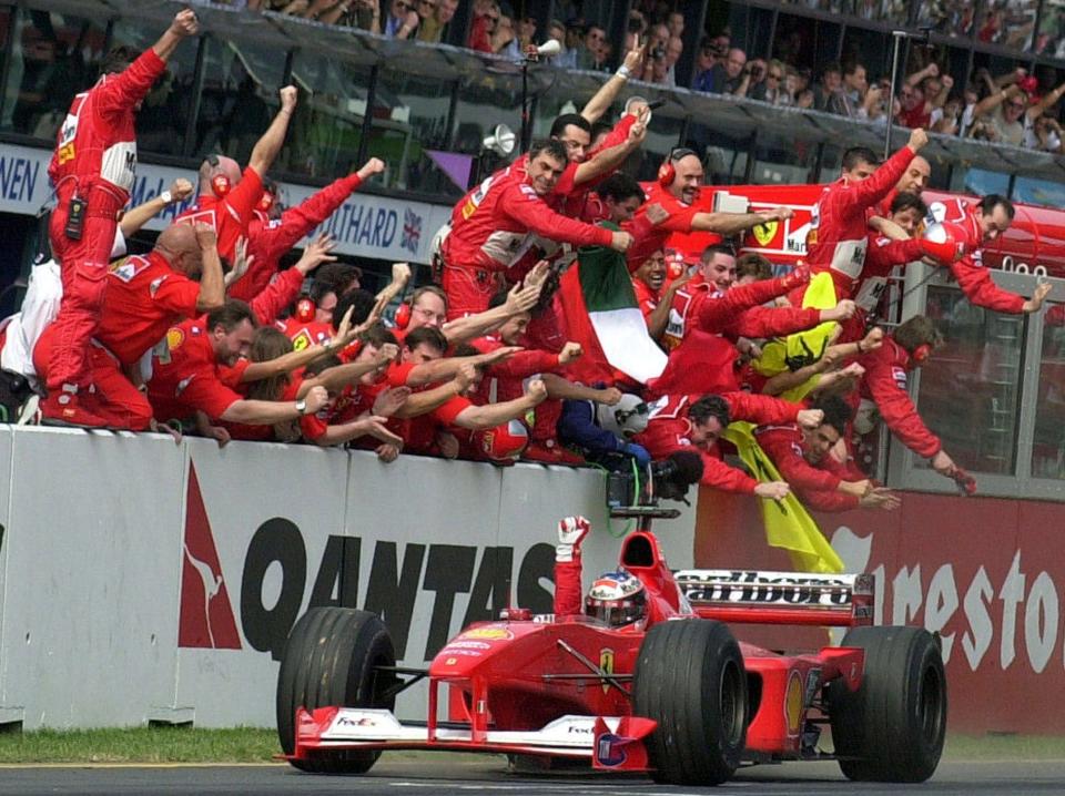 Michael Schumacher...FILE - In this March 12, 2000 file picture, Ferrari driver Michael Schumacher of Germany is cheered by his pit crew as he heads for the finish line to win the Australian Formula One Grand Prix in Melbourne. Seven-time Formula One champion Schumacher is making a comeback for Ferrari to replace injured driver Felipe Massa it was announced Wednesday July 29, 2009. Schumacher will get back in the cockpit until Massa is fit to return. The next race is the European Grand Prix on Aug. 23 in Valencia. (AP Photo/Rick Rycroft) - Credit: Rick Rycroft/AP