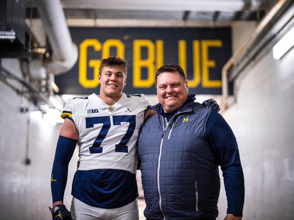 Vandegrift's Blake Frazier poses with his father, Steve, after a recruiting visit to Michigan. He pledged to the Wolverines this spring. Steve Frazier was an offensive lineman for Michigan in the late 1990s.