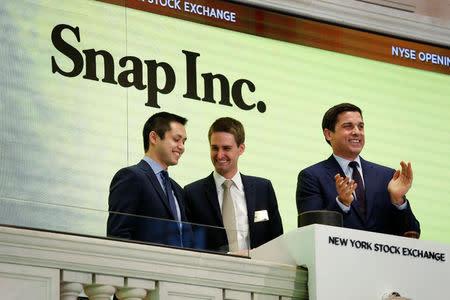 Snap cofounders Evan Spiegel (C) and Bobby Murphy ring the opening bell of the New York Stock Exchange with NYSE Group President Thomas Farley. REUTERS/Lucas Jackson