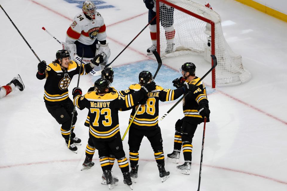 Boston Bruins' Tyler Bertuzzi, left, moves in to congratulate David Pastrnak after he scored on Florida Panthers goaltender Alex Lyon during the first period of game 1 of an NHL hockey playoff series, Monday, April 17, 2023, in Boston. (AP Photo/Winslow Townson)