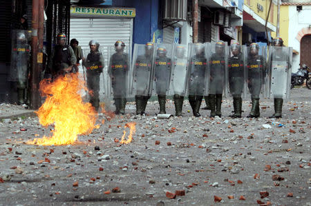 Security forces look on while clashing with opposition supporters participating in a rally against Venezuelan President Nicolas Maduro's government and to commemorate the 61st anniversary of the end of the dictatorship of Marcos Perez Jimenez in Tachira, Venezuela January 23, 2019. REUTERS/Carlos Eduardo Ramirez